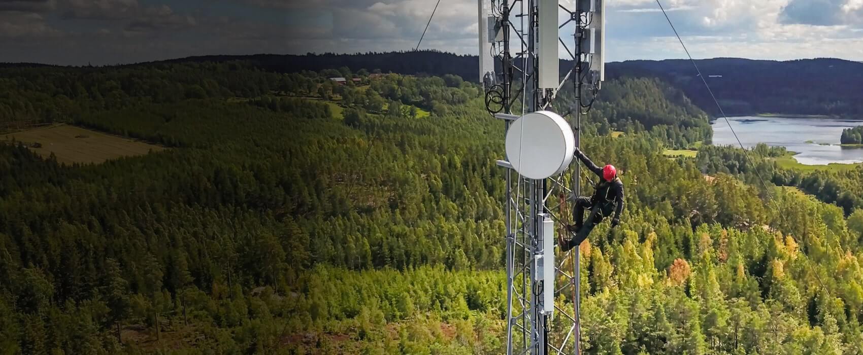 Workers climbing on a transmission tower