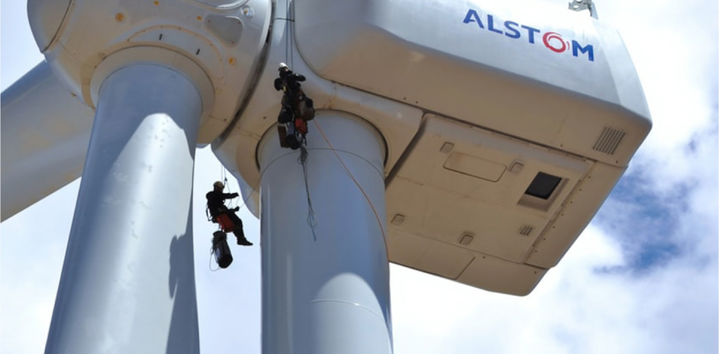 Two men climbing a windwheel